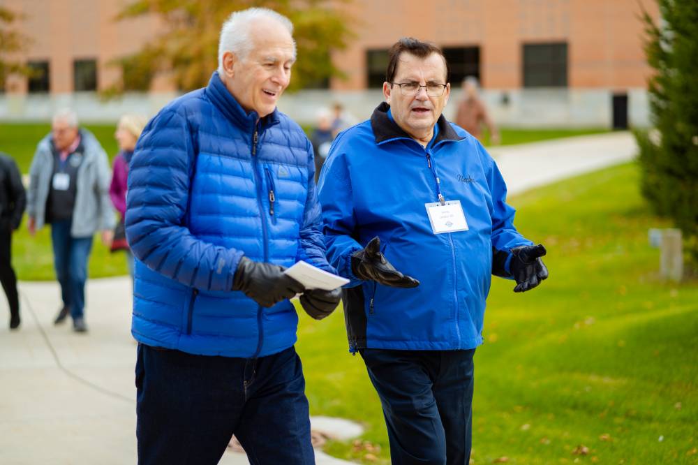 two men catch up while on campus tour